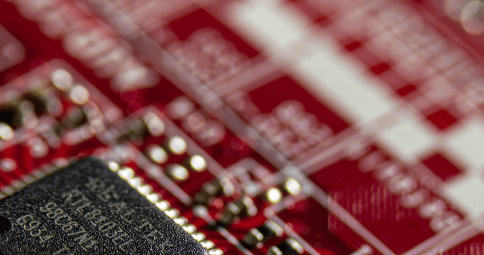 Close-up of a red circuit board and microchip