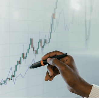Hand pointing at business analytics charts